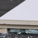 Expanded perlite insulation beneath construction panels for lightweight thermal insulation applications
